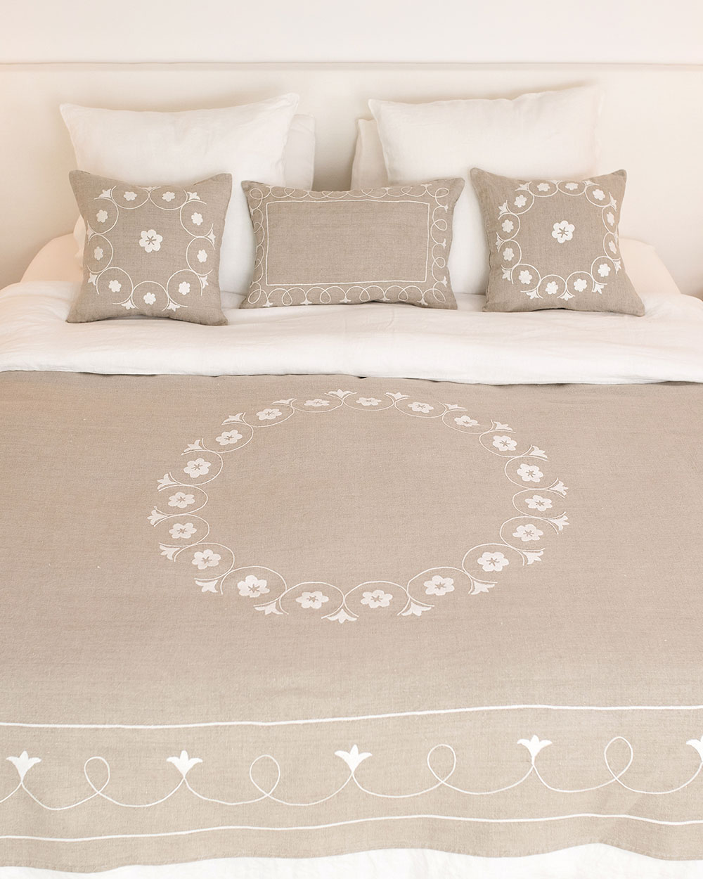 Couvre-lit brodé en lin naturel Shamya sur un lit, broderie blanche